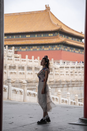 Woman with Traditional Contemporary Chinese costume and headband in Forbidden City in Beijing, China.の写真素材