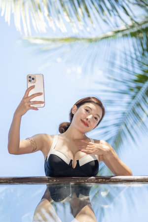 Woman in swimsuit enjoy relax with tropical green garden background.の写真素材