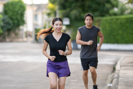 Couple running outdoor in nature for exercise, cardio together.の写真素材