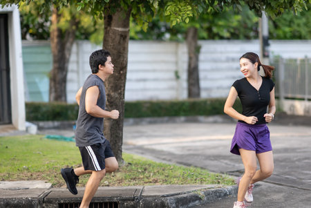 Couple running outdoor in nature for exercise, cardio together.の写真素材