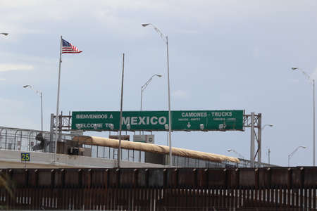 Border of Mexico and the United States, with flags and walking bridge connecting El Paso Texas to Juarez, Mexicoの写真素材