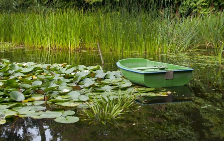 Green fishing boat on the lake の写真素材