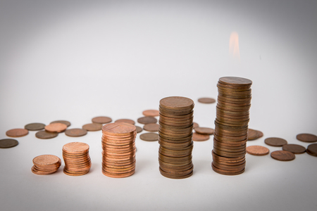 a stack of coins at the white background isolatedの写真素材