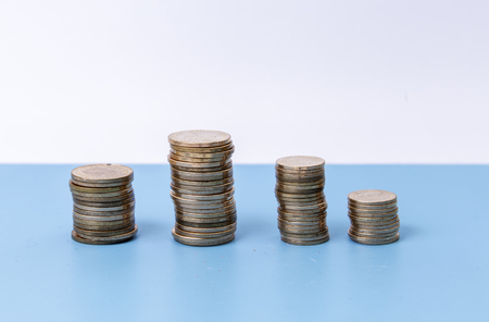 A stack of coins isolated at the blue table, financeの写真素材