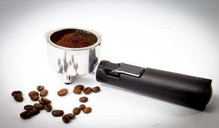 coffee portafilter at the white background with coffee been and powderの写真素材