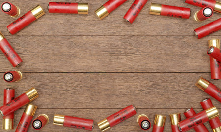 3d render illustration of a shotgun ammunition on wooden background. Border formed from a bunch of...