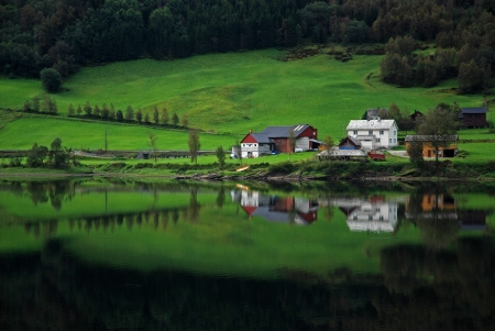 Norway landscape with houses reflected in waterの写真素材