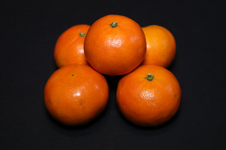 Mandarin and thermometer on a black background.の写真素材