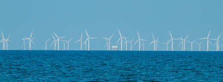 View of the windmills by the sea in a village in Walesの写真素材