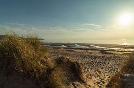 Sunset over the Irish Sea in the village of Barmouth in Wales, United Kingdomの写真素材