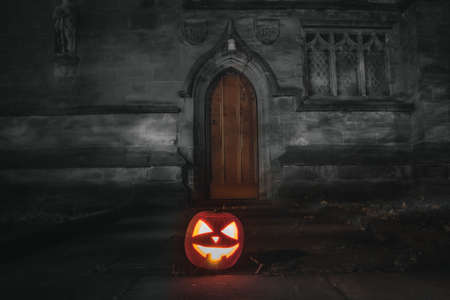 Hallowen pumpkin in front doors in church , United Kingdom 2021.の写真素材