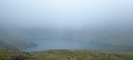 Cader Idris mountain with lake near the town of Dolgellau, in National Park Snowdonia in Wales, misty morning 2022.の写真素材