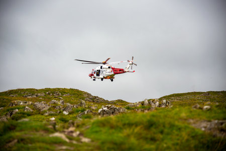 The Hm RescueGuard rescue helicopter, above Helvellyn Peak in the National Park Lake District 2022のeditorial素材