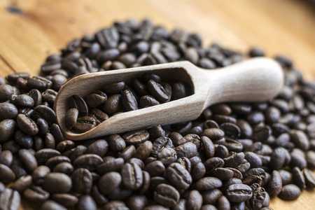 coffee beans with wooden scoopの写真素材