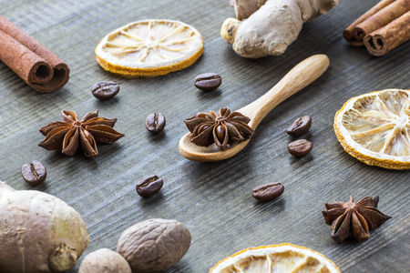 star anise on wooden spoon with spicesの写真素材