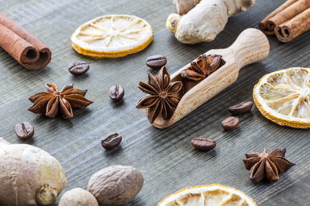 star anise on wooden spoon with spicesの写真素材