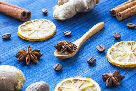 star anise on wooden spoon with spicesの写真素材