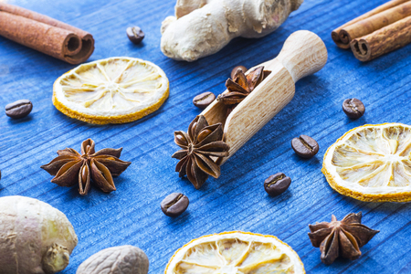 star anise on wooden spoon with spicesの写真素材