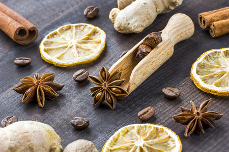 star anise on wooden spoon with spicesの写真素材