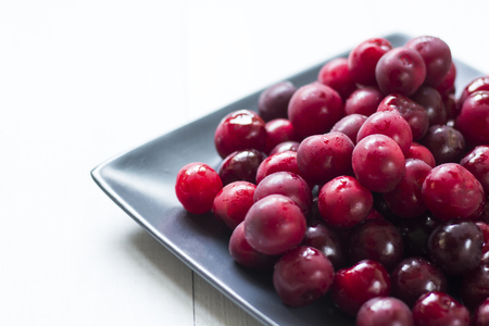 fresh sweet cherries on gray plateの写真素材