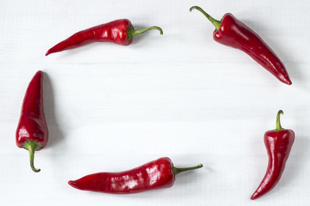 cayenne chilli peppers on wooden backgroundの写真素材
