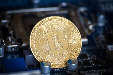 coin with bitcoin logo on computer parts. bussines of cryptocurrency background