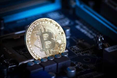 coin with bitcoin logo on computer parts. bussines of cryptocurrency background