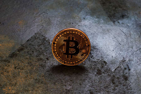 Bitcoin logo coin on rusty metal background