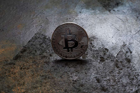 Bitcoin logo coin on rusty metal backgroundの写真素材