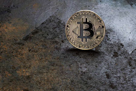 Bitcoin logo coin on rusty metal background