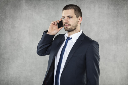 serious businessman talking on the phoneの写真素材