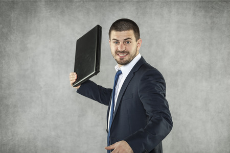 angry businessman ready to destroy a laptopの写真素材