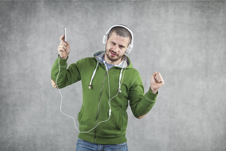 young boy listening to musicの写真素材