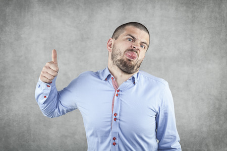 young businessman with thumb raised upの写真素材