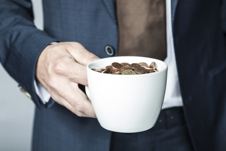 cup of small coinsの写真素材