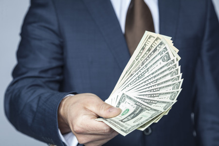 man hand holding dollarsの写真素材