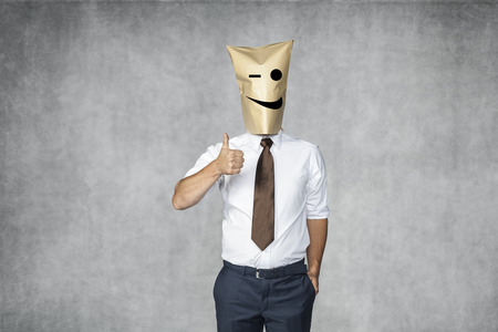 man with emoticon face showing Thumbs Upの写真素材
