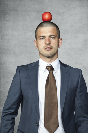 businessman with apple on the headの写真素材