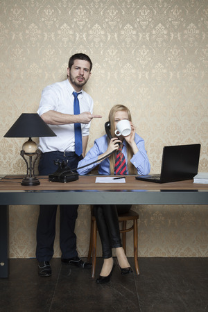 angry businessman explains how to workの写真素材