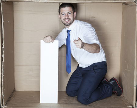businessman in the small office pointingの写真素材