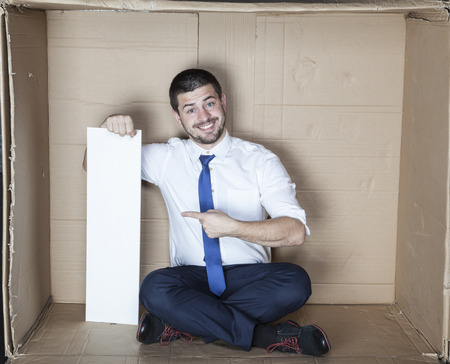 happy businessman pointing to the copy spaceの写真素材