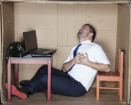 Businessman gets a heart attack at workの写真素材