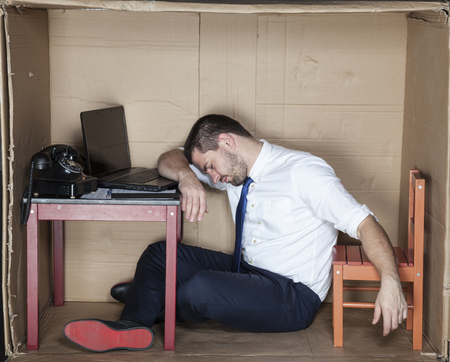 Tired businessman asleep in the officeの写真素材