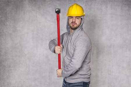 young worker with a big hammerの写真素材