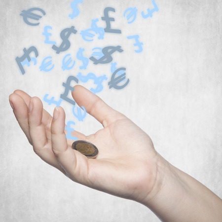 two euros on his hand, currency symbols in the backgroundの写真素材