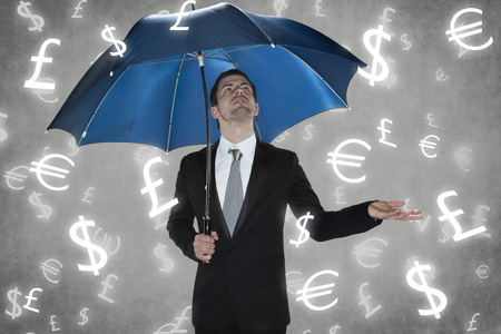 businessman under the rain currenciesの写真素材