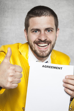 businessman in a gold suit and thumbs up, the new agreementの写真素材