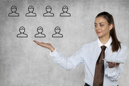 businesswoman shows how to easily manage peopleの写真素材