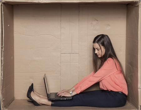 business woman working in her tight office on the computerの写真素材