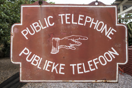 very old information sign about a public telephone, Africaの写真素材